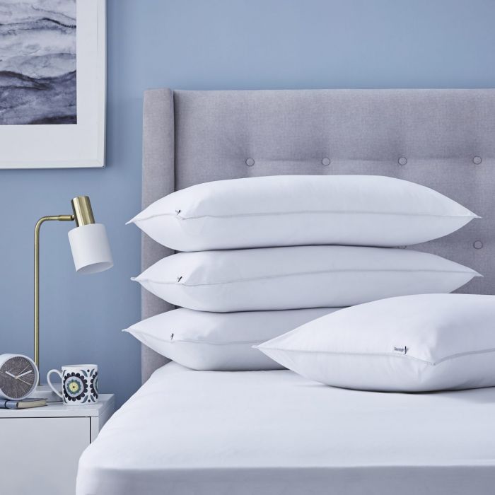 pillows stacked up on a bed
